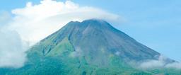Clouds hover over Arenal Volcano verdant eastern slope on June 24, 2009.