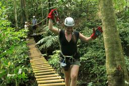 A visitor walks across the monkey bridge on the full day jungle adventure tour on Oct. 5, 2013.